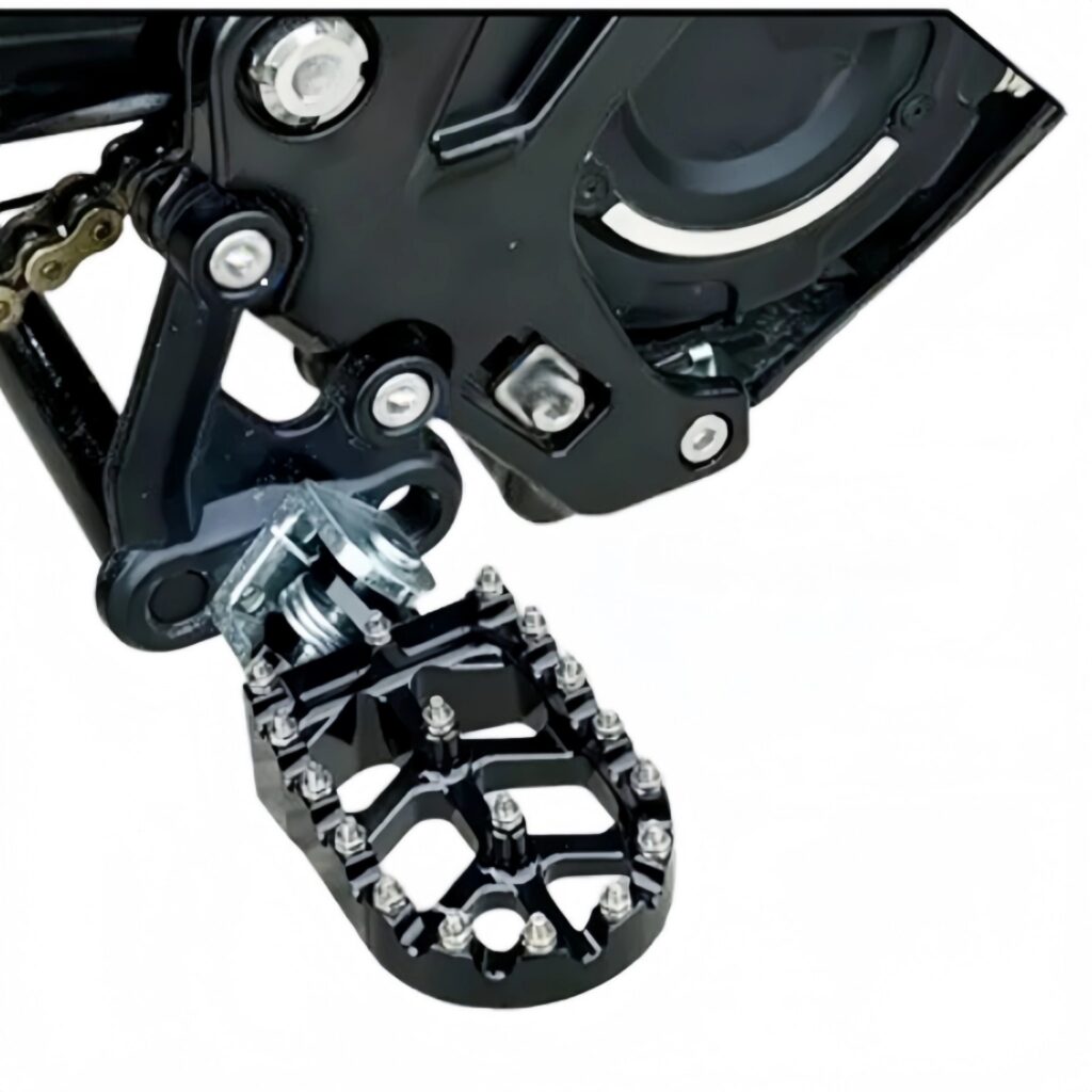 Black CNC wide foot pegs installed on Sur-Ron Light Bee close-up